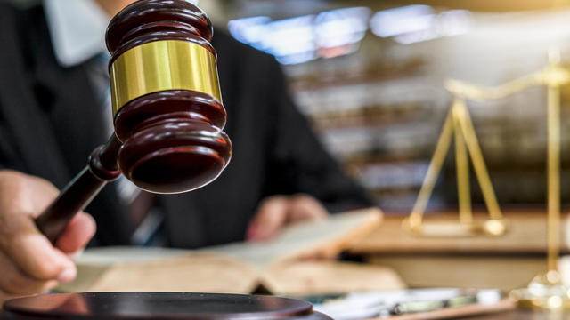 Close up of judge holding gavel